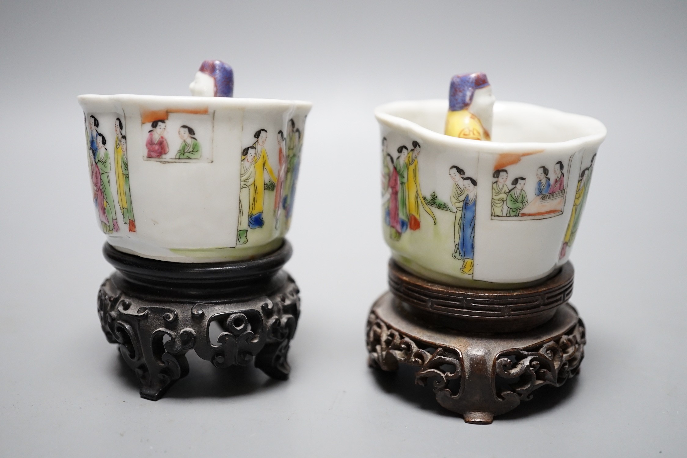 A pair of 19th century Chinese famille rose puzzle cups on stands, 8cm tall overall